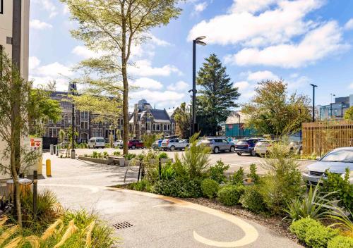 a street with cars parked in a parking lot at Hotel Give in Christchurch