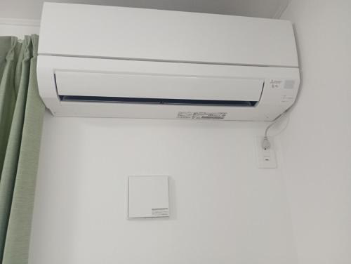 a printer sitting on a wall next to a curtain at ShirokumaHouse - Vacation STAY 24594v in Wakayama