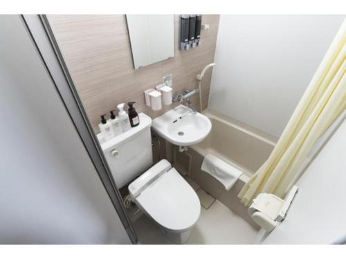 a small bathroom with a toilet and a sink at HOTEL STARRIZE - Vacation STAY 25108v in Fukuoka