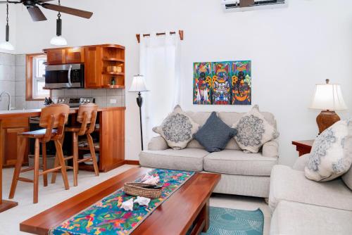 a living room with a couch and a table at Residences at Barrier Reef Casita 3 by Stay Floreo in San Pedro Island
