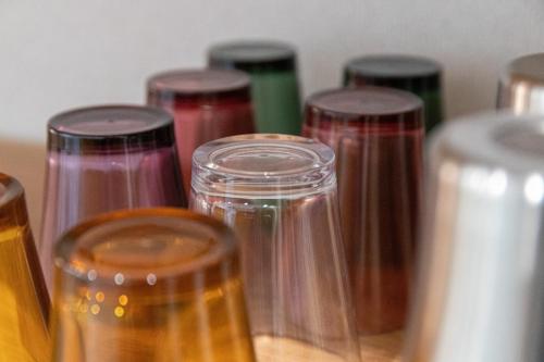 a group of different colored glass jars on a table at CAN LI ASSO - Vacation STAY 25193v in Minami Aso