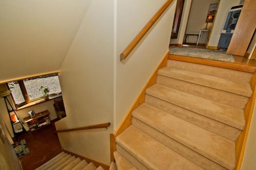 a stairway in a home with wooden stairs at White Lotus House in Crestone