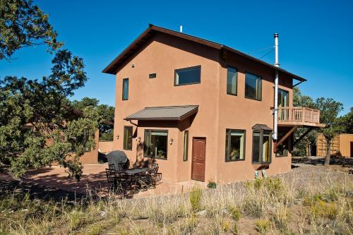 a large house with a balcony on top of it at White Lotus House in Crestone