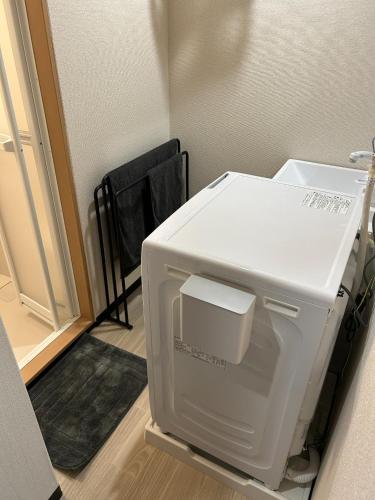 a white refrigerator sitting in a room next to a door at Sirius AMA - Vacation STAY 20068 in Tsukuba