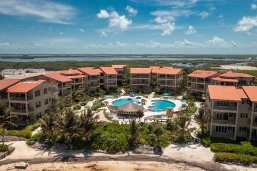 an aerial view of a resort with swimming pools at Residences at Barrier Reef 1-3B Oceanfront 2 BR by Stay Floreo in San Pedro Island