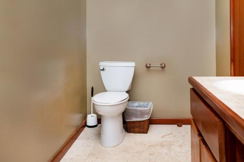 a bathroom with a toilet and a sink at Residences at Barrier Reef 1-3B Oceanfront 2 BR by Stay Floreo in San Pedro Island
