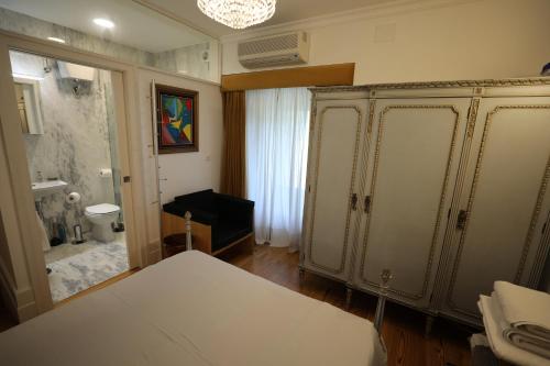 a bathroom with a toilet and a large white cabinet at Casa dos Macieis - Entire Main House, Entire Guesthouse or Separate Wing of Main House - Camino Santiago direct access & Optional Agritourism in Facha