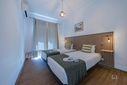a hotel room with two beds and a window at MouraLua in Sintra