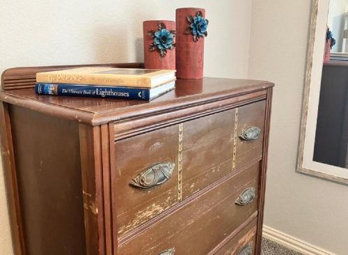 a wooden dresser with books on top of it at The Texas Bluebonnet Home in Historic McKinney in McKinney