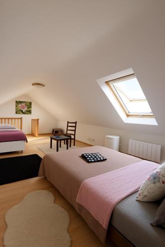 a bedroom with two beds and a skylight at Roissy CDG, private room 4 in Roissy-en-France