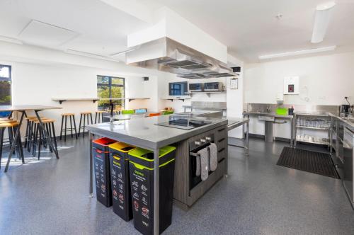 a large kitchen with an island in the middle at Hotel Give in Christchurch