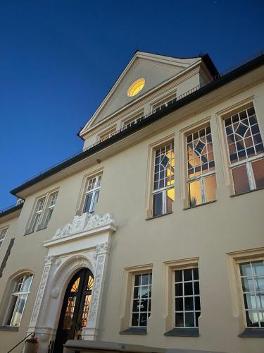 a building with a clock on the top of it at Schloss Krugsdorf Golf & Hotel in Krugsdorf