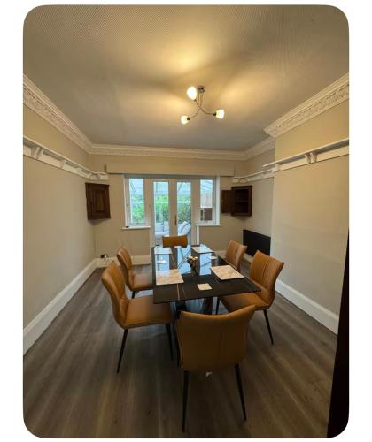 a dining room with a table and chairs at Shubh stays in Buxton