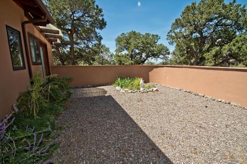 a backyard with a retaining wall and a garden at White Lotus House in Crestone