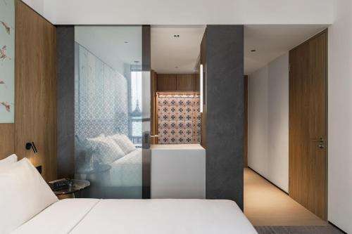 a bedroom with a white bed and a shower at Crowne Plaza Penang Straits City by IHG in Perai
