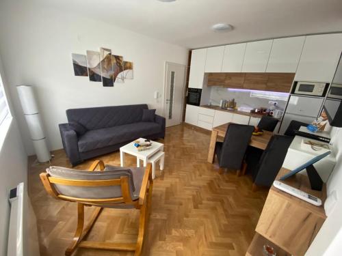 a living room with a couch and a table at Apartman Sunny, Vrnjacka Banja in Vrnjačka Banja