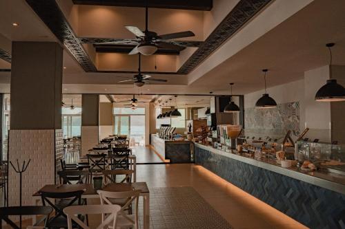 a restaurant with a bunch of tables and chairs at Oceano Palace in Mazatlán