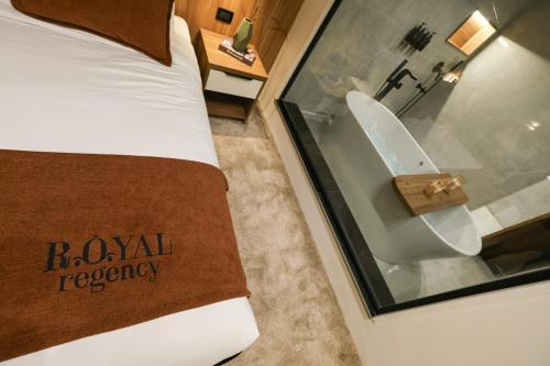 a hotel room with a bed and a bathroom with a tub at Royal Regency Hotel in Cairo