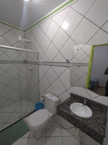 a bathroom with a toilet and a sink at Kayc pousada in Amargosa