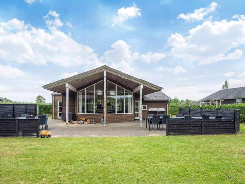 a pavilion with tables and chairs in a field at 10 person holiday home in Ansager-By Traum in Ansager