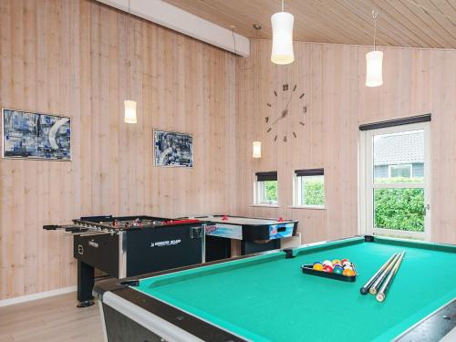 a billiard room with a pool table and a clock at 10 person holiday home in Ansager-By Traum in Ansager