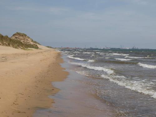 an empty beach with the ocean and waves at 2 person holiday home in Skagen-By Traum in Skagen
