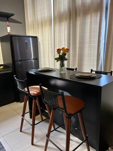 a kitchen with a table with two chairs and a refrigerator at Cabana Canyon in Barracão