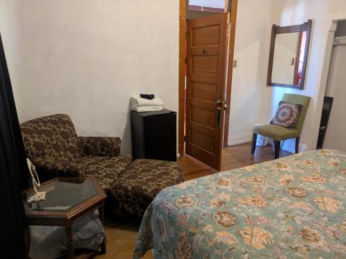a hotel room with a bed and a couch and a chair at The Oliver House - Adults Only in Bisbee