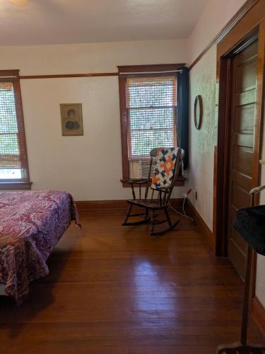a bedroom with a bed and a chair in it at The Oliver House - Adults Only in Bisbee