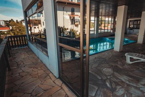 a view of the pool from the balcony of a house at Hotel Alpenrose in Treze Tílias