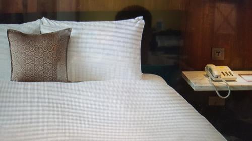 Voodi või voodid majutusasutuse Berkeley Business Hotel Zhongzheng toas