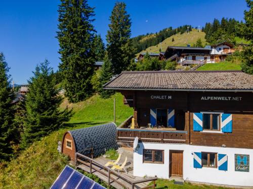 a house with solar panels in front of it at Chalet H XL in Königsleiten