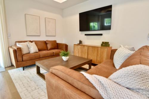 a living room with two couches and a tv at Luxury New Construction Cottage with fireplace, office, and covered deck in Gastonia