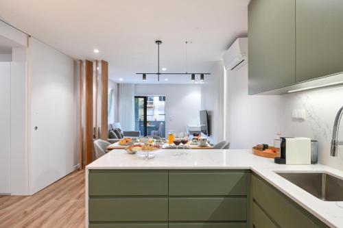 a kitchen with a sink and a counter top at ON Apartments - Matosinhos Premium - Free Parking & Pet Friendly in Matosinhos