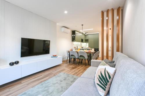 a living room with a couch and a tv on a wall at ON Apartments - Matosinhos Premium - Free Parking & Pet Friendly in Matosinhos