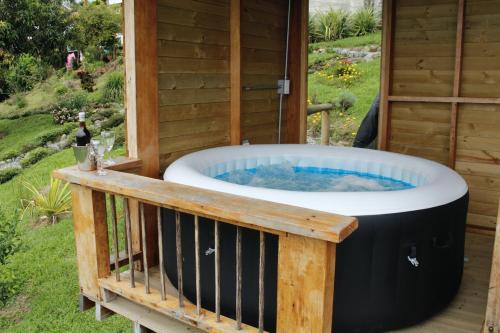 a hot tub on a deck with a bottle of wine at Glamping La Sucursal del Cielo in Támesis