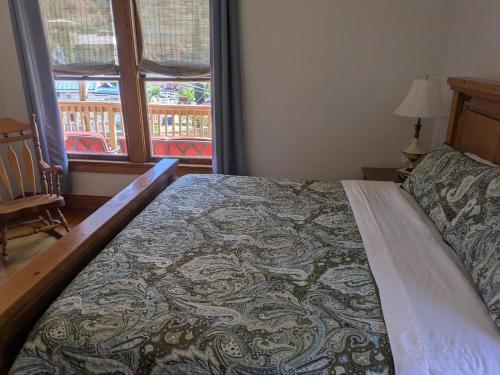 a bedroom with a bed and a window with a view at The Oliver House - Adults Only in Bisbee