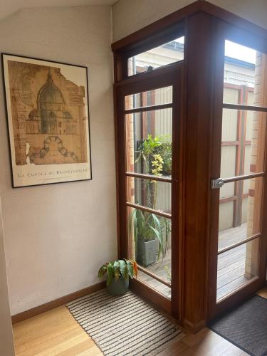 a door in a room with a plant next to it at Nelson - architect designed oasis Port Melbourne in Melbourne