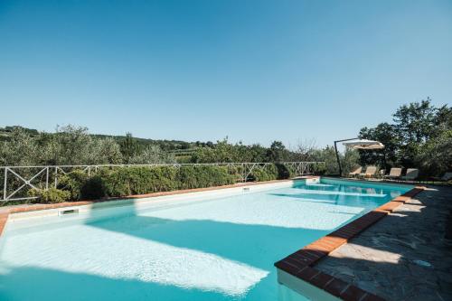 a large swimming pool with blue water at Charming Farmhouse in Monteleone D'Orvieto in Monteleone dʼOrvieto