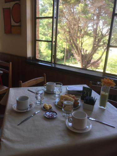 a table with cups and plates of food on it at Italia in La Falda