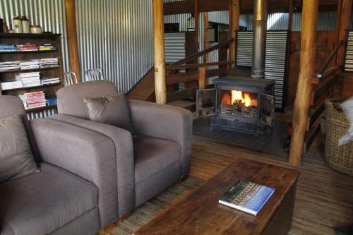 a living room with two couches and a fireplace at Black Sheep Inn in Orange