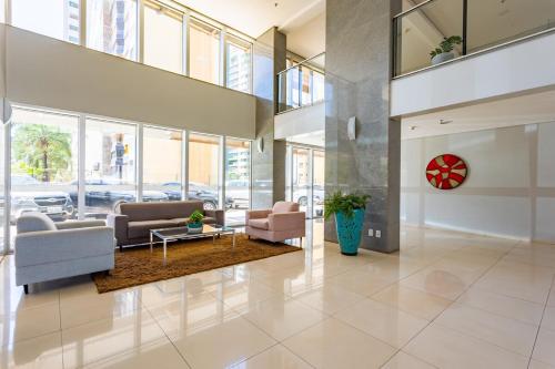 a lobby with couches and a table in a building at Luxury apartment next to Águas Claras Shopping Mall in Brasilia