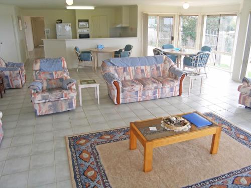 a living room with couches and a coffee table at Waterview House in Greenwell Point