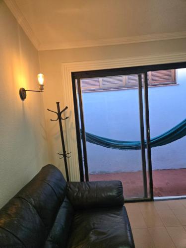 a living room with a couch and a large window at Elegant House with Party Room in Santana do Livramento
