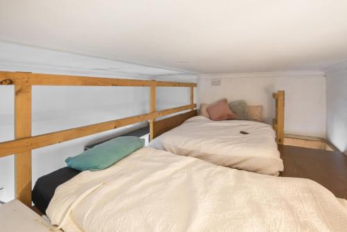 a bedroom with two bunk beds in it at Carlton loft studios. Tiny house movement. in Melbourne