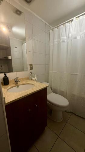 a bathroom with a sink and a toilet and a mirror at A pasos del estadio Mundial Sub20 Talca in Talca