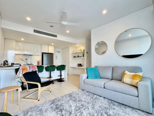 a living room with a couch and a kitchen at River View Apartment South Brisbane in Brisbane