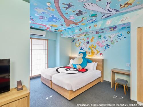 a bedroom with a bed with a ceiling covered in animals at MIMARU Tokyo Ginza East in Tokyo