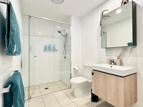 a bathroom with a shower and a sink and a toilet at River View Apartment South Brisbane in Brisbane