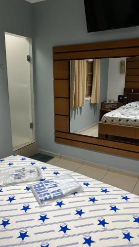 a bedroom with a bed with blue stars on it at Hotel estrela da lapa in Sao Paulo